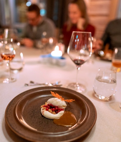 A gourmet dinner served with a glass of red wine.