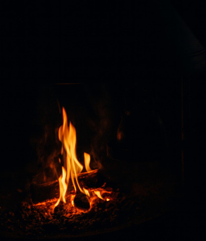 Warm glowing fire flames in a cozy fireplace creating a relaxing and intimate ambiance