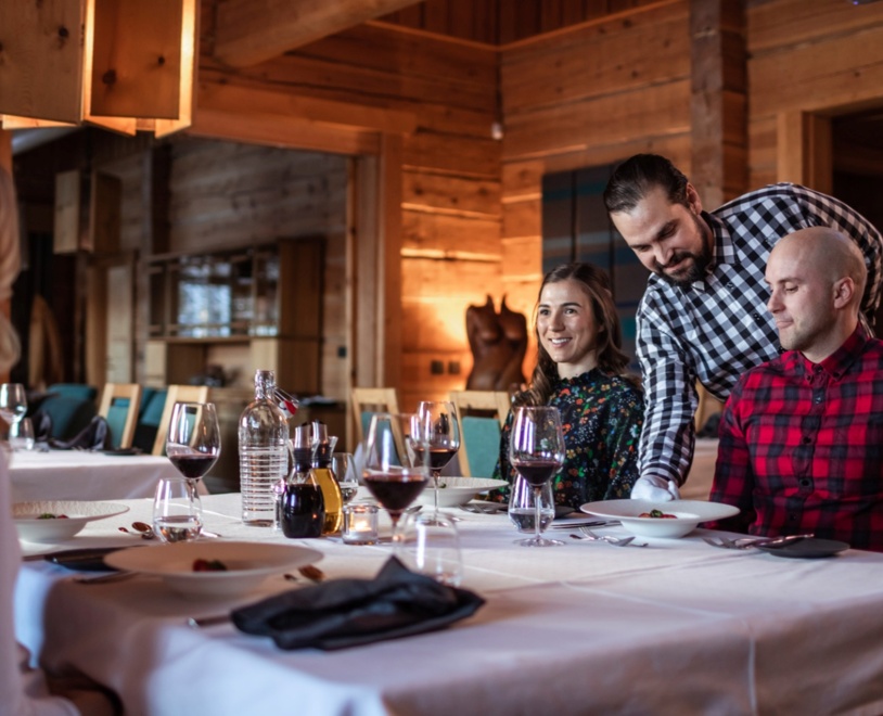 Patrons enjoying their meals and a glass of red wine at Restaurant Aihki.