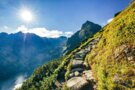 Scenic mountain trail paved with stones, leading through picturesque terrain.