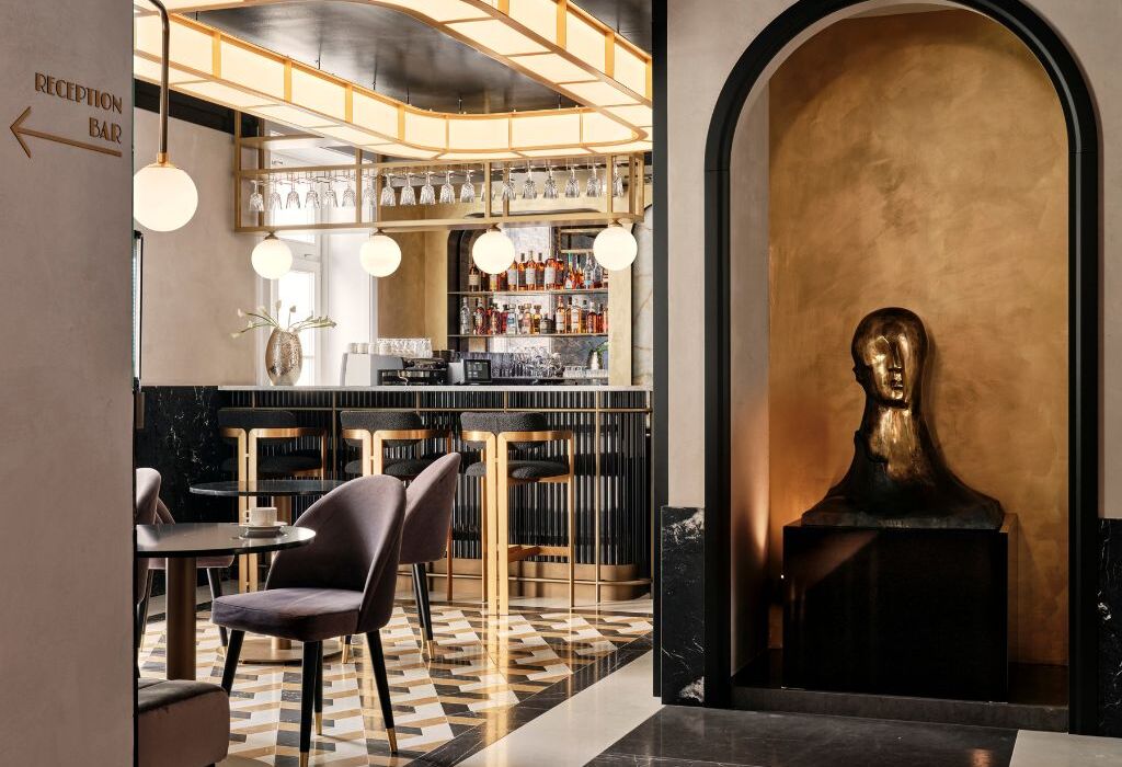 Elegant hotel bar with sculptures, mosaic, and atmospheric light
