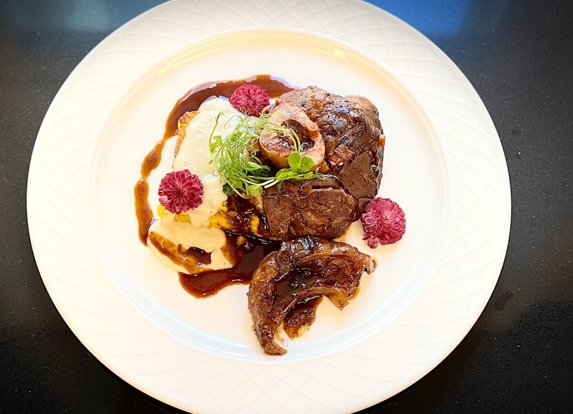 meat dish with edible flowers – fine dining experience at best Italian restaurant in cracow
