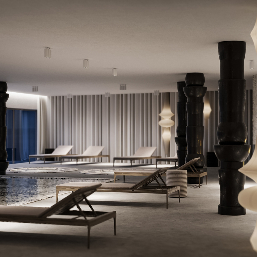 Innen-Spa mit flachem, spiegelndem Becken, hölzernen Liegen, skulpturalen schwarzen Säulen, Kaminfeuer und warmem Stimmungslicht