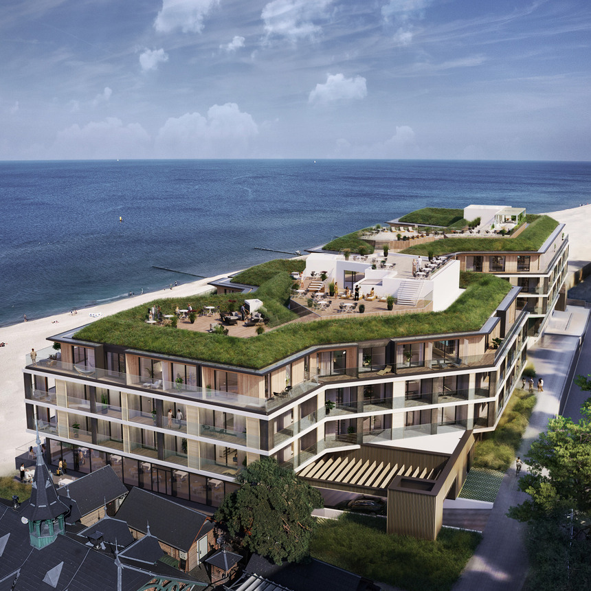 Modern beachfront hotel with layered glass balconies and green rooftop terraces, outdoor seating, direct sandy beach access and sea views.