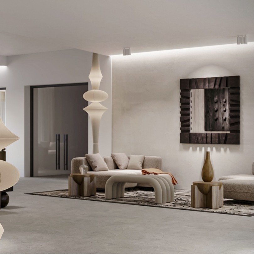 Nowoczesne lobby hotelowe z rzeźbiarskimi lampami, kamiennymi akcentami, zaokrągloną sofą i pufami na wzorzystym dywanie, miękkie oświetlenie