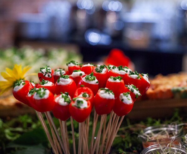 Skewered mini red peppers stuffed with creamy cheese and chives, elegant buffet appetizer display