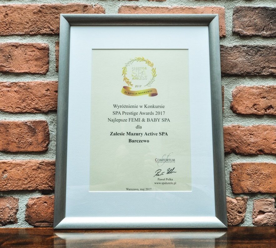 SPA Prestige Awards 2017 certificate for Zalesie Mazury Active SPA in a silver frame against an exposed brick wall