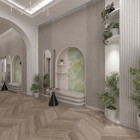 Eleganckie lobby hotelowe z łukowymi wnękami i siedziskami, zielonym onyksem, roślinami, subtelnym oświetleniem i drewnianą podłogą.